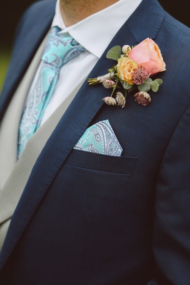 man in suit with pastel paisley tie