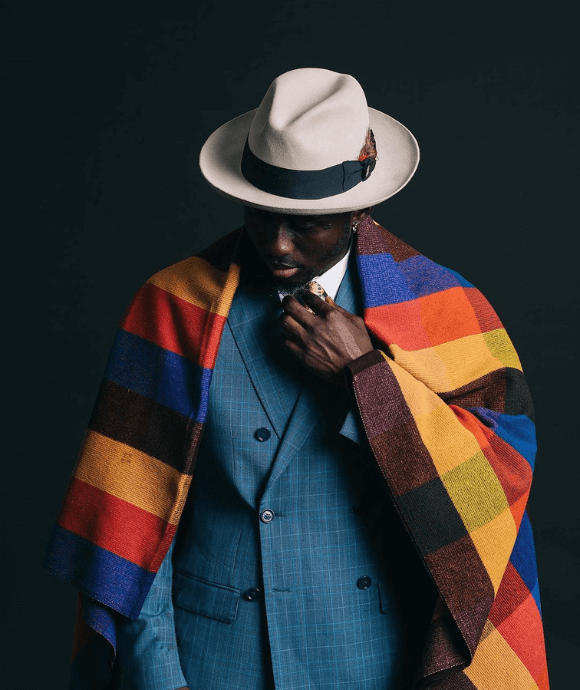 Man with a colorful scarf wearing a coat.
