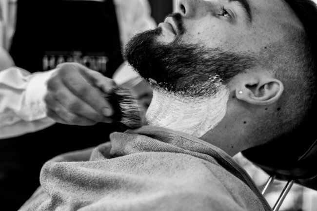 man trimming beard at barber