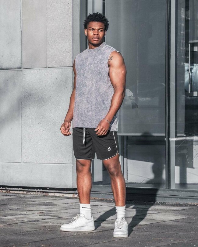 Athletic shorts paired with tank top offer a sporty look. 