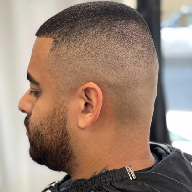 A low maintenance bald fade with line-up haircut. 