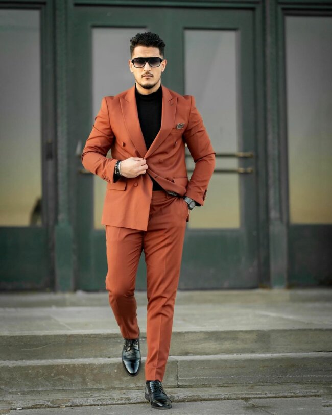 A classy bold look with a burnt orange suit.