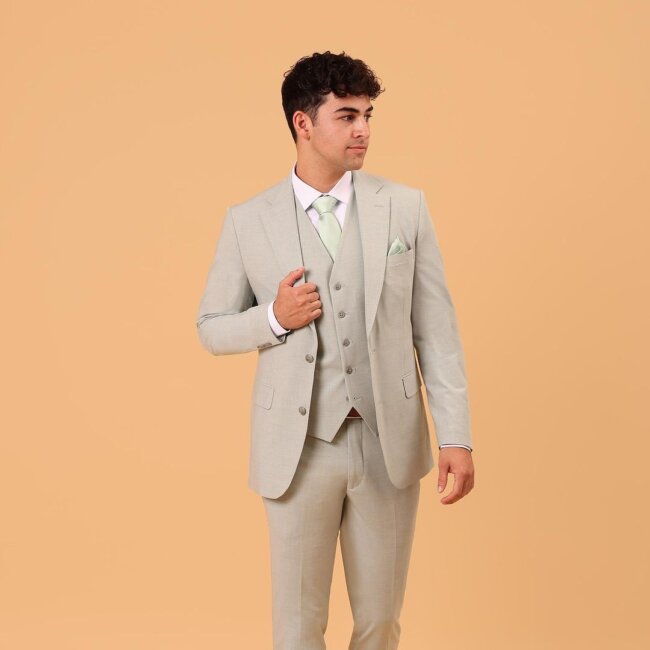 A stylish outfit with a cream colored suit. 