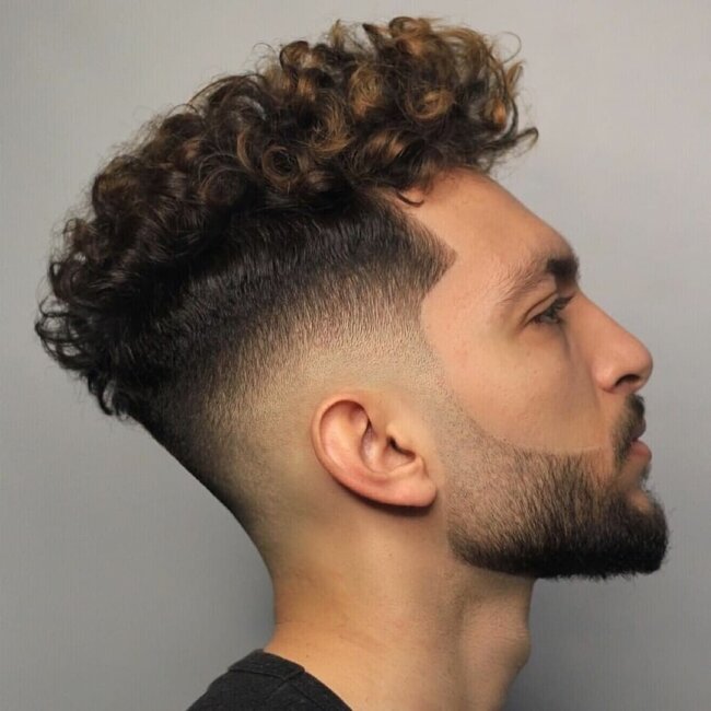 A classy curly fade haircut.