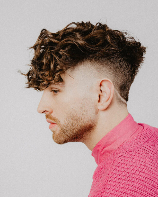 An edgy look with a curly faux hawk haircut. 