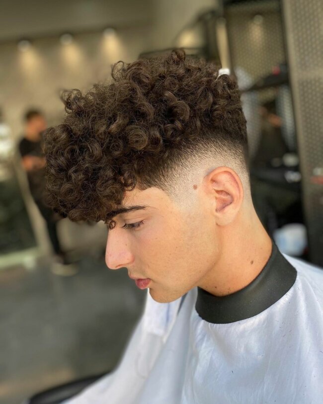 A sleek look with a curly high top fade. 