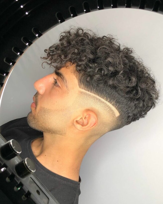 A unique look with a curly top with a hard part. 