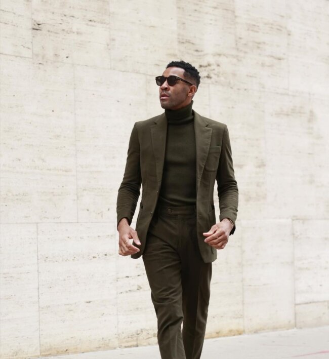 A dark outfit featuring forest green shades. 