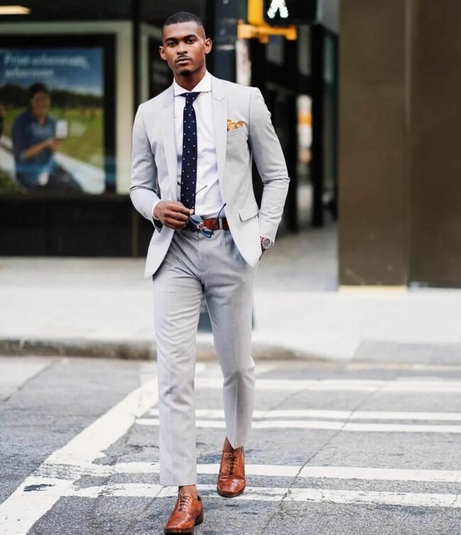 A sophisticated outfit featuring light gray suit. 