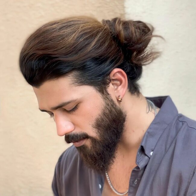 A chic appearance with long hair and a beard. 