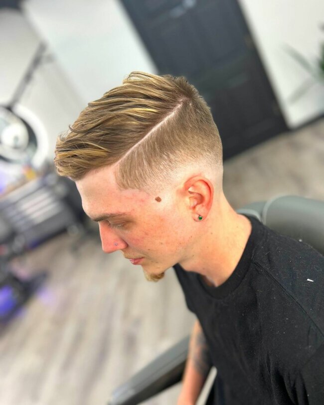 A unique and classy mid fade with side part haircut.
