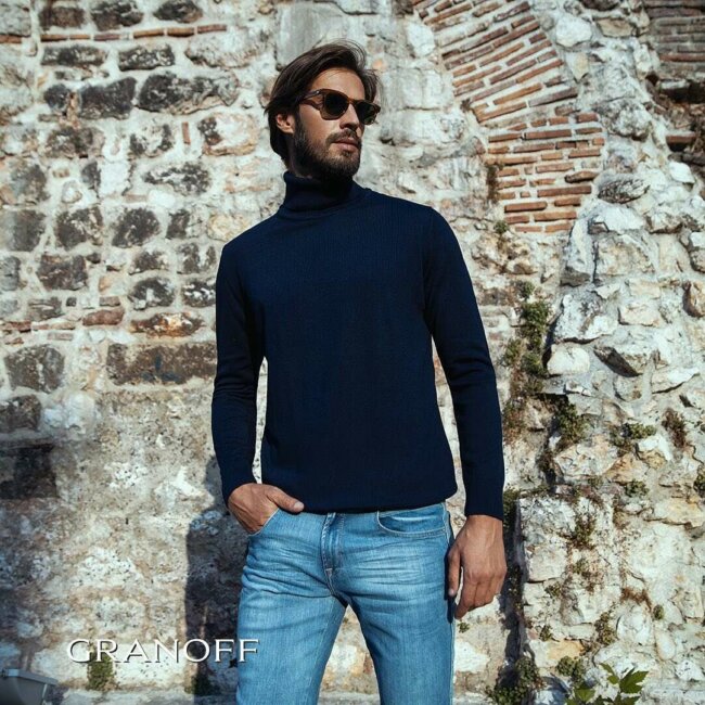 A refined formal look with a navy blue turtleneck.