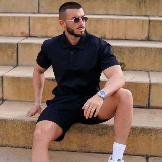 Polo shirt paired with tailored shorts provide a chic appearance.
