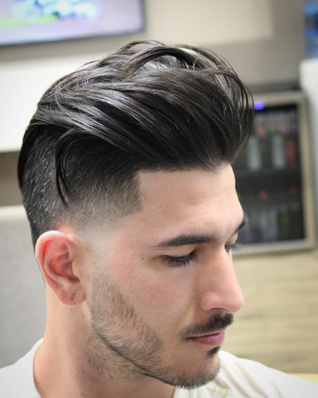 A unique and classy look with a pompadour haircut. 
