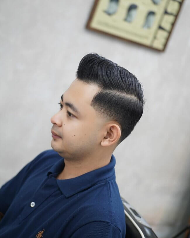 A sleek look with side part and taper fade. 