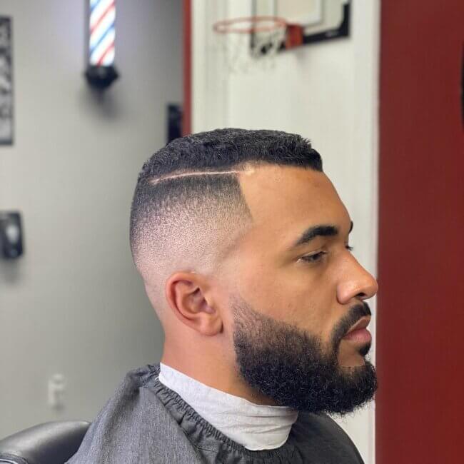 A cool and classy look with skin fade and hard part. 