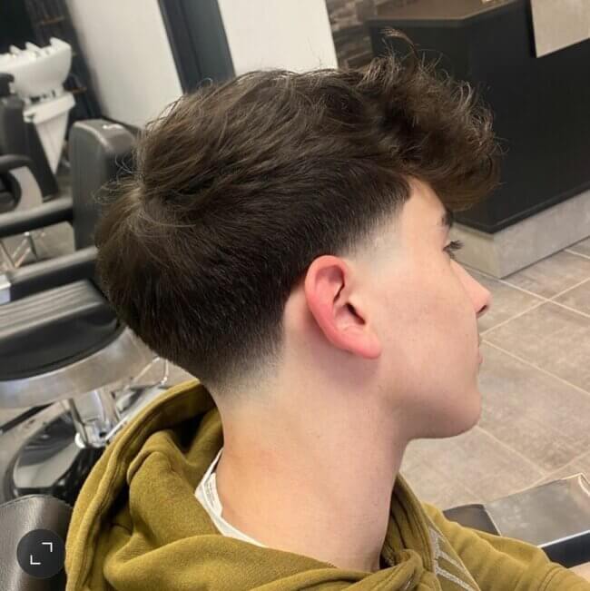 A unique look featuring taper fade with quiff. 